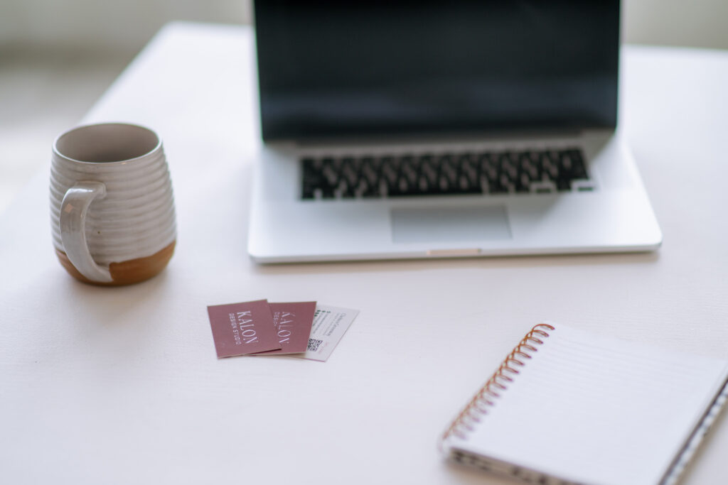 Brand messaging framework quick reference workspace with notebook, coffee, and laptop